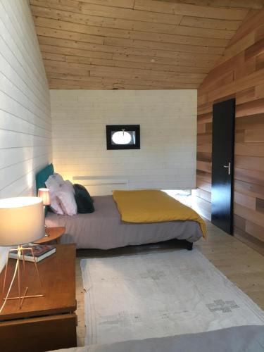 a bedroom with a bed and a small window at le 25bis in Saint-Martory