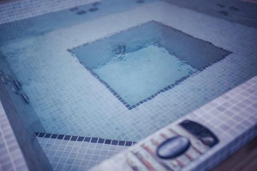 a picture of a swimming pool with a remote control at The Old Hotel Ravel Centre in Clermont-Ferrand