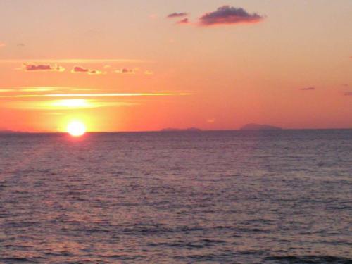 a sunset over the ocean with the sun in the sky at Hotel Ristorante Antica Marina in Nicotera Marina