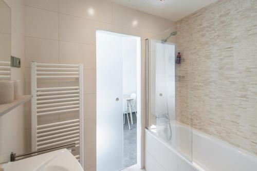 a white bath tub sitting next to a white toilet at Apartment Slavikova 11 in Prague