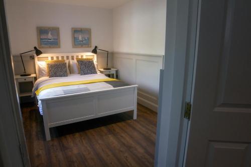 a bedroom with a bed with two pillows on it at The Nest in Youghal