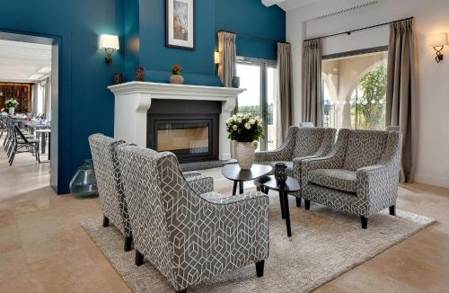 a living room with chairs and a fireplace at La Bastide de Biot in Biot