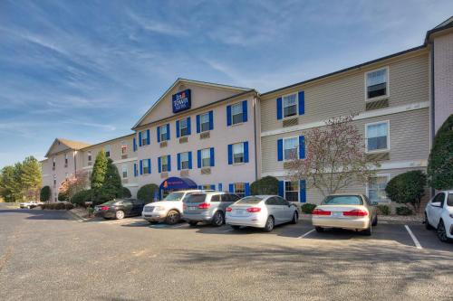 a hotel with cars parked in a parking lot at InTown Suites Extended Stay Kannapolis NC in Kannapolis