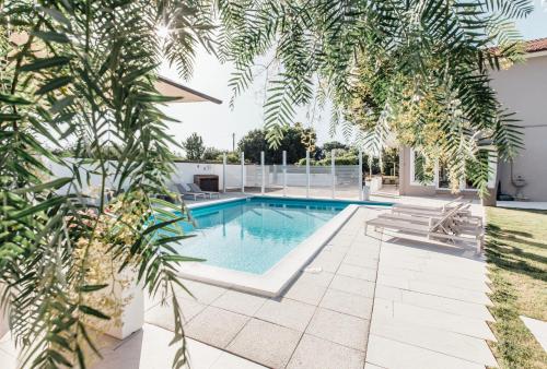 a pool in the backyard of a house with plants at Suite 106 in Vasto