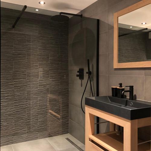 a bathroom with a black sink and a shower at Studio 23 in Zandvoort