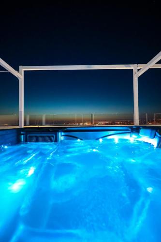 a swimming pool at night with a view of the city at Boutique Apartments Ad Astra in Bibinje