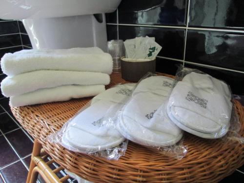 a basket filled with towels and white towels at Hotel I Colori in SantʼAntìoco