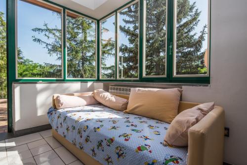 a room with a couch in front of windows at Belvedere di Gloria in Tramonti