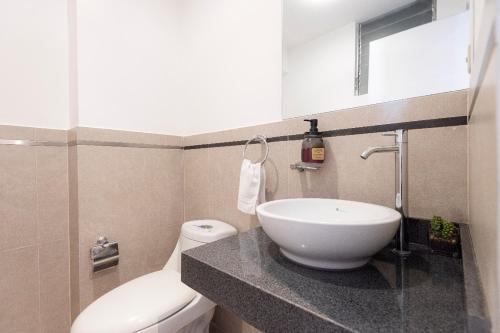 a bathroom with a sink and a toilet at El Triunfo Apartments in Cusco