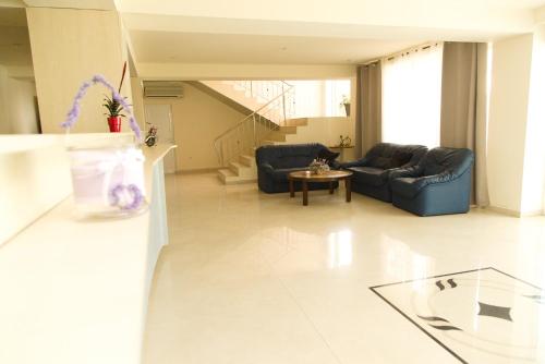 a living room with two blue couches and a table at Eden in Timişoara