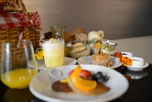 a table topped with plates of food and drinks at Raw Culture Art & Lofts Bairro Alto in Lisbon