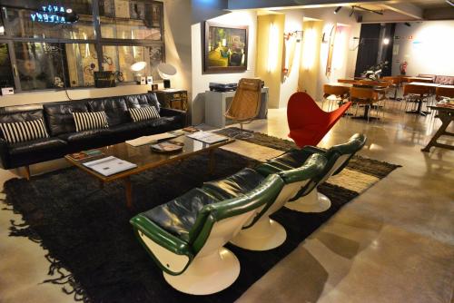 a living room with a couch and chairs and a table at Raw Culture Art & Lofts Bairro Alto in Lisbon