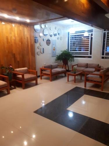 a lobby with couches and chairs and a table at Casa Nativa Iquitos in Iquitos