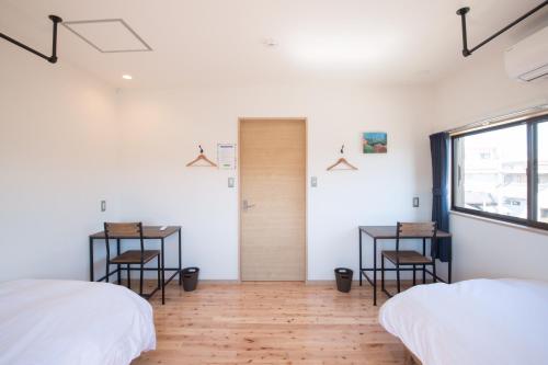 Postel nebo postele na pokoji v ubytování Shioya Hostel