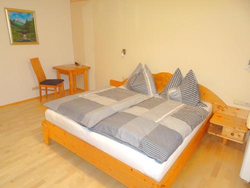 a bedroom with a large wooden bed with pillows at Appartement Christine in Grossarl