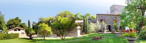 a house with a yard with trees and plants at Antico Podere Vitiano - Luxury country house in Castel Viscardo