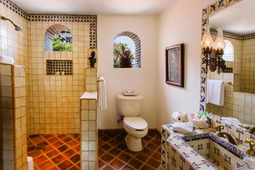 a bathroom with a toilet and a shower at Hacienda San Angel in Puerto Vallarta