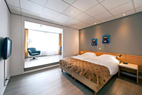 Postel nebo postele na pokoji v ubytování City Hotel Bergen op Zoom