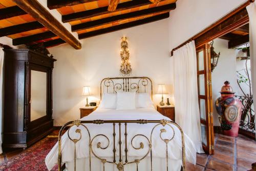 a bedroom with a white bed in a room at Hacienda San Angel in Puerto Vallarta