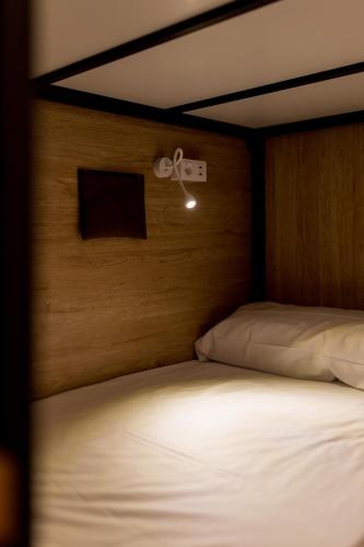 a close up of a bed with a head board at Hostel Nüt in Granada