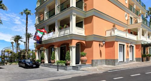 a building with a car parked in front of it at Grand Hotel Royal in Sorrento