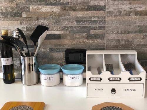 a counter top with a kitchen utensils and a box at Xenia House in Lascari