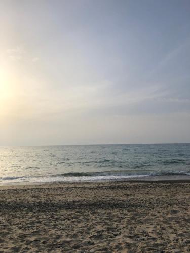 an empty beach with the ocean in the background at Xenia House in Lascari
