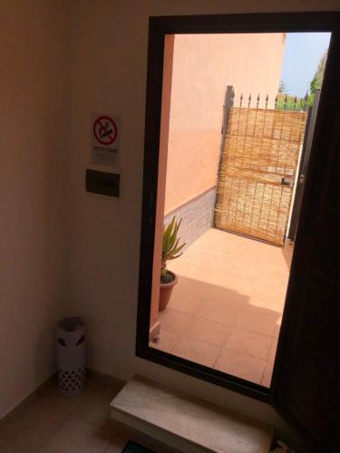 a mirror in a room with a door to a patio at Xenia House in Lascari