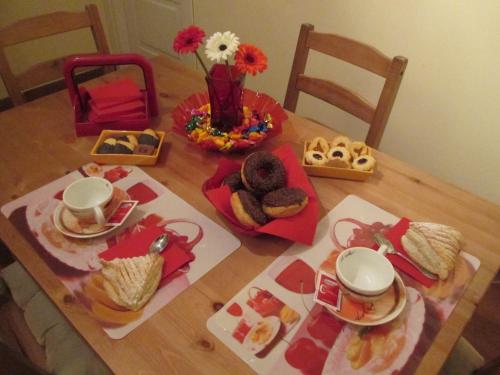 a wooden table with food and drinks on it at La Dolce Casetta in Grottaferrata