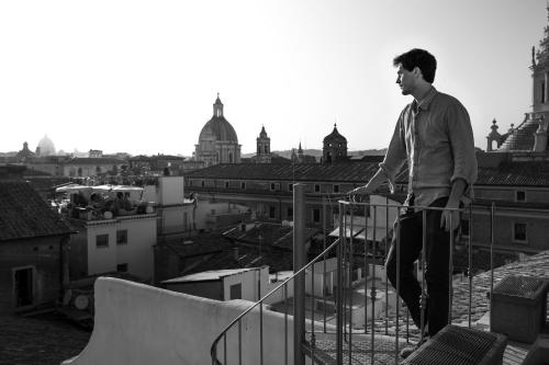 a man standing on top of a balcony with a skateboard at Sant'Ivo Apartments in Rome