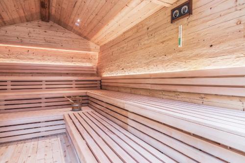 an empty wooden sauna with wooden walls and ceilings at Feldmilla Design Hotel - Wellness & SPA in Campo Tures