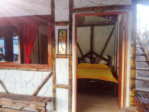 an open door to a bedroom with a bed at Cabañas Guacari San Agustín huila in San Agustín