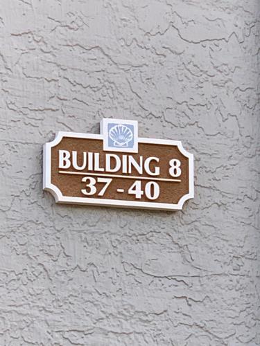 a building sign on the side of a wall at Sea Club Condo #37 in Clearwater Beach