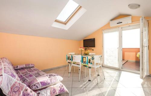 a bedroom with a bed and a table and a tv at MILKA APARTMANI POVLJANA in Povljana