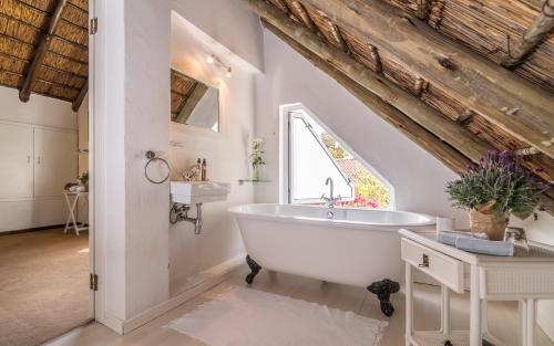 a bathroom with a white tub and a sink at Green Park Manor in Johannesburg