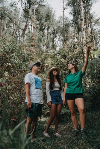 a group of three people standing in a forest at Levit Glamping - Hotel Guatapé Peñol in Guatapé
