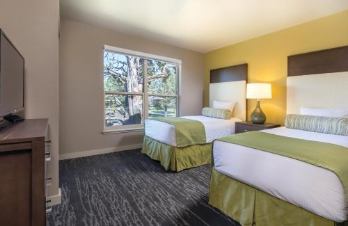 a hotel room with two beds and a window at WorldMark Eagle Crest in Redmond