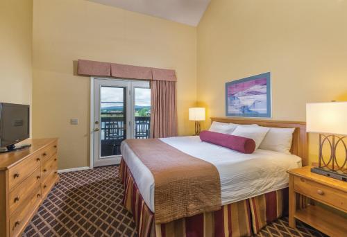 a hotel room with a bed and a television at Club Wyndham Pagosa in Pagosa Springs