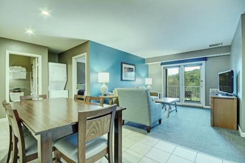a dining room and living room with a table and chairs at Club Wyndham Bentley Brook in Hancock
