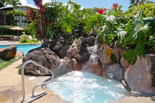 a water slide in a pool with a waterfall at Club Wyndham Ka Eo Kai in Princeville