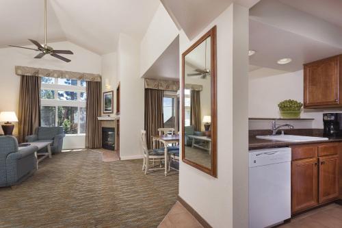 a kitchen and living room with a sink and a mirror at WorldMark South Shore in Zephyr Cove