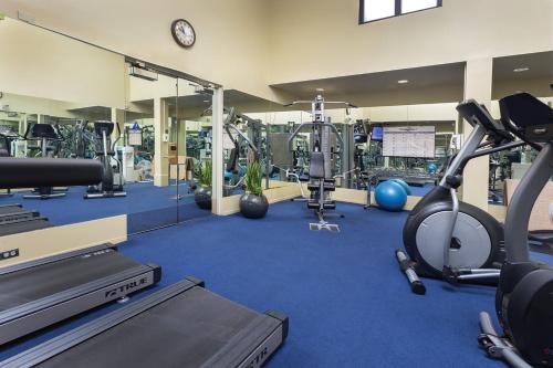 a gym with several treadmills and exercise machines at The Donatello Hotel in San Francisco