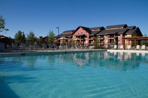 a large swimming pool with chairs and a building at WorldMark Steamboat Springs in Steamboat Springs