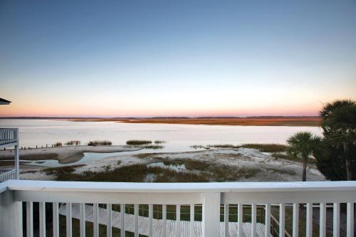 a view from the balcony of a house overlooking the ocean at Club Wyndham Ocean Ridge in Edisto Island