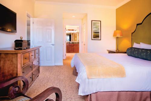 a bedroom with a large bed and a television at WorldMark Reunion in Kissimmee