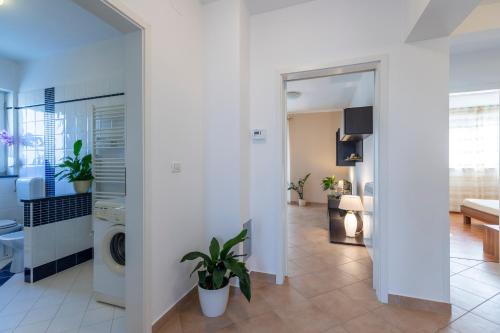 a living room with white walls and a washing machine at Holiday house Mary in Barban