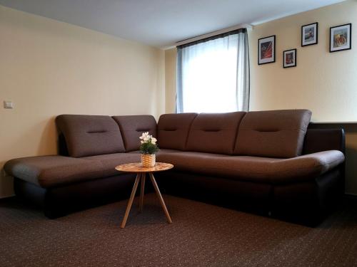 a living room with a couch and a table at Kamus in Baden-Baden