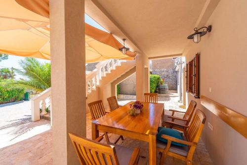 a dining room with a wooden table and chairs at Holiday home Privlaka/Zadar Riviera 8218 in Batalaži