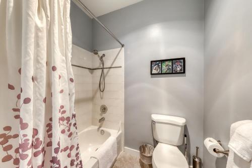 a bathroom with a white toilet and a shower curtain at Belltown Court North in Seattle
