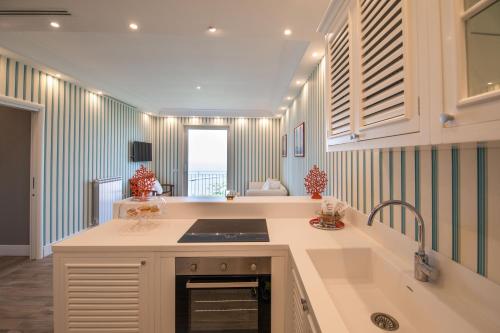 a kitchen with a sink and a counter top at Le Fratte Luxury Home in Castellammare di Stabia